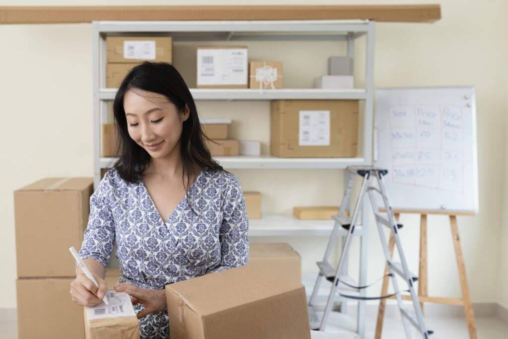 young-woman-writing-details-delivery-box
